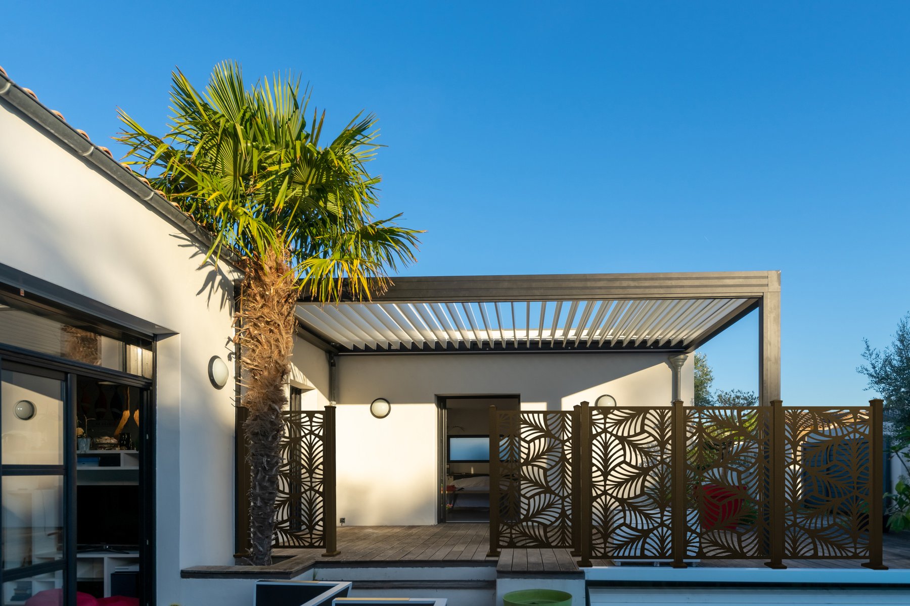 Bronze Palm & Fronds screens on a modern patio
